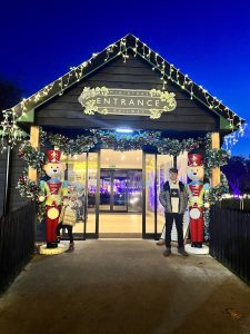Essex Mums visits Audley End Railway Christmas Experience. 2 children outside the Entrance to the railway experience with Christmas decorations.