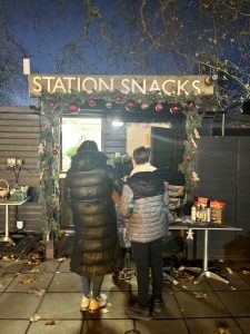 Essex Mums visits Audley End Railway Christmas Experience. Snack hut, family getting drinks & snacks.