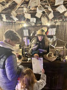 Essex Mums visits Audley End Railway Christmas Experience. Letter writing to Father Christmas - an elf and 2 children.